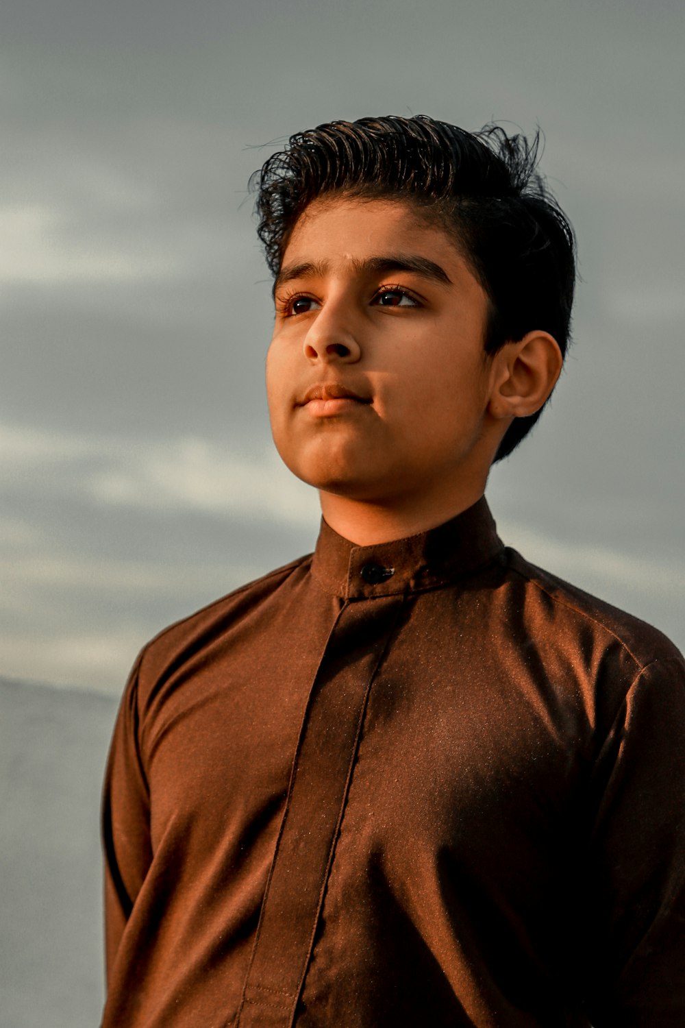 boy in brown button up shirt