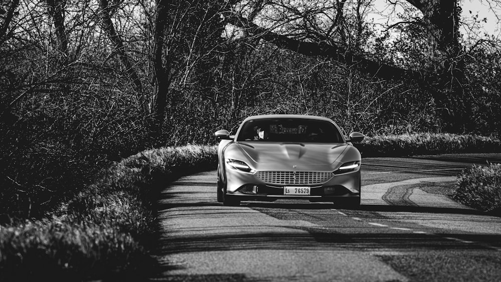 grayscale photo of car on road