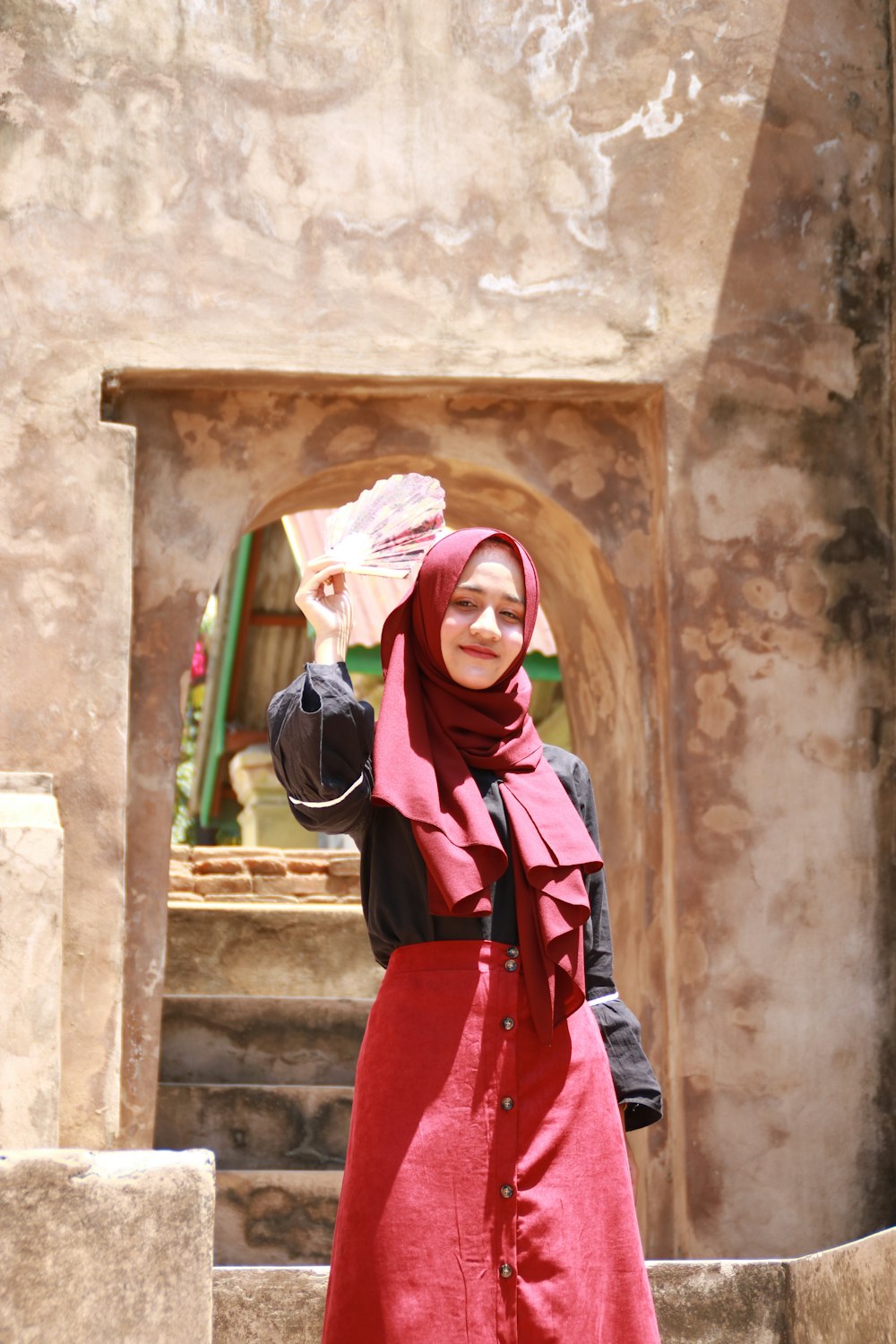 woman in black hijab and red long sleeve dress