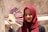 woman in red hijab holding hand fan