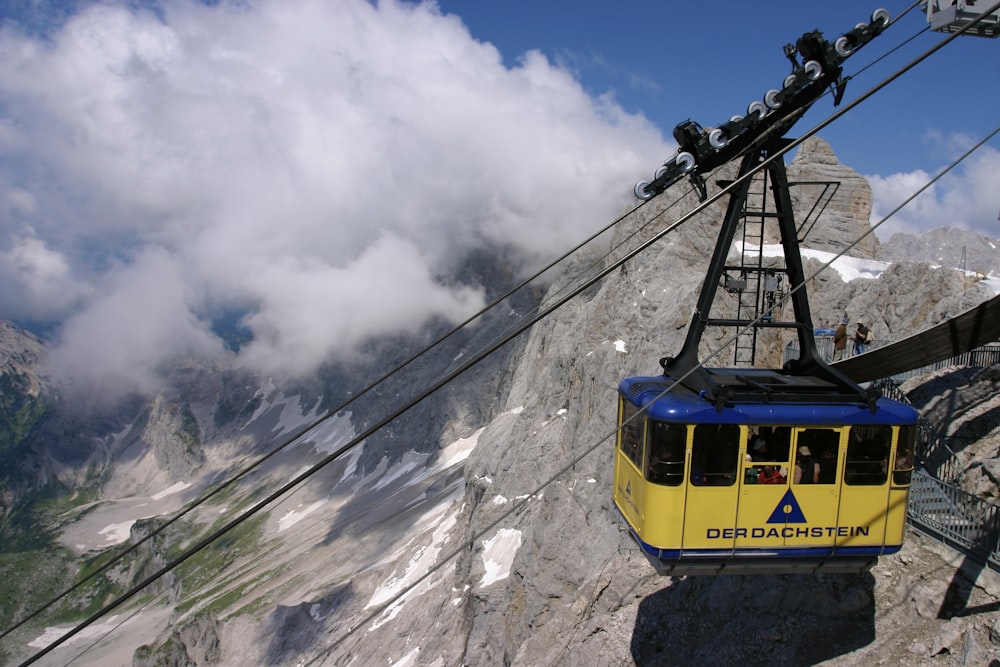 yellow and black cable car over the mountains