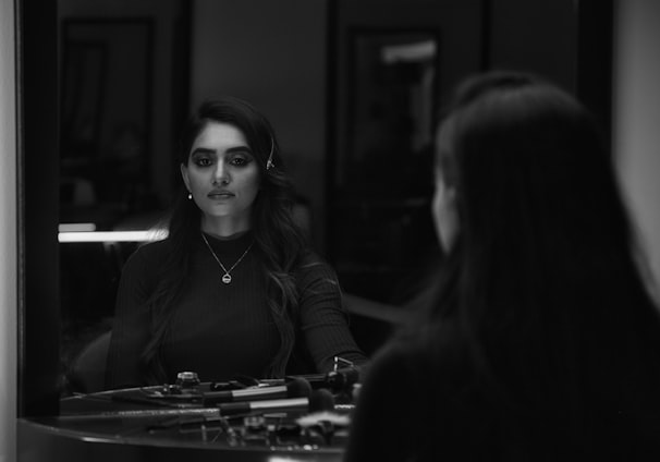 woman in black jacket sitting beside woman in black jacket