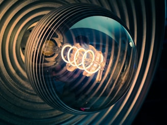 A close-up of magnetic field lines swirling around a glowing electromagnet.