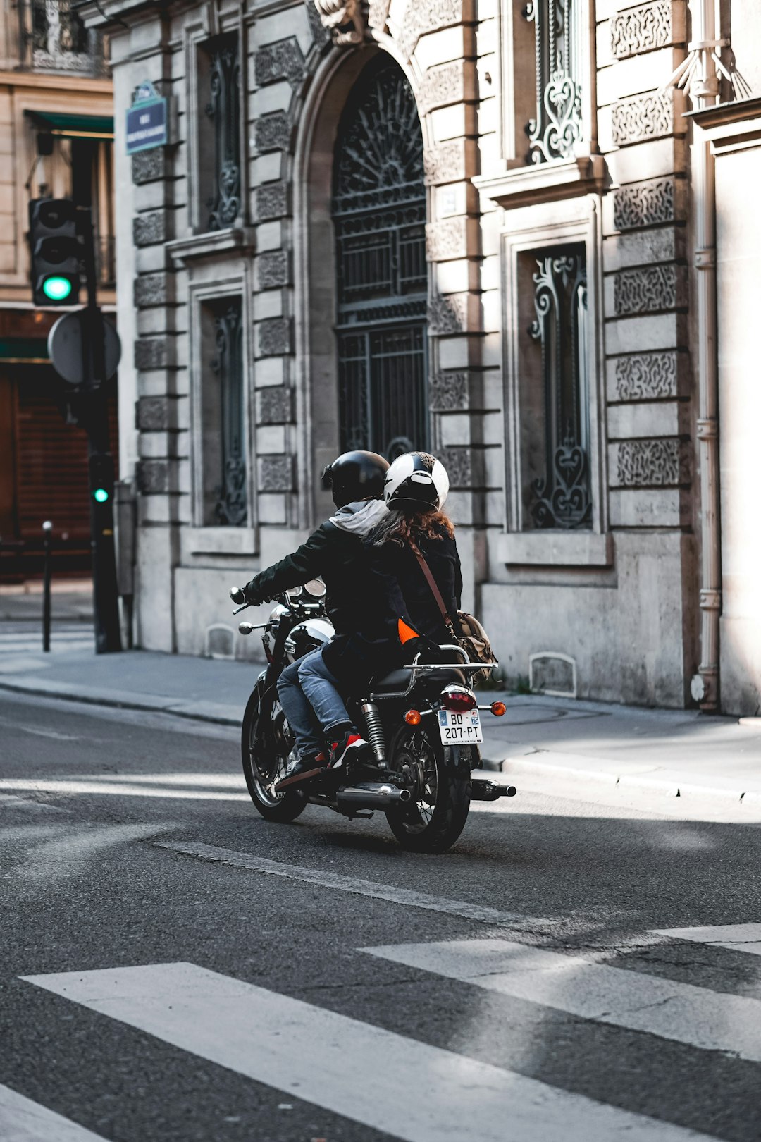 man in black jacket riding motorcycle on road during daytime