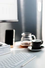 A modern workspace with a laptop, notebook, and pen on a clean desk.