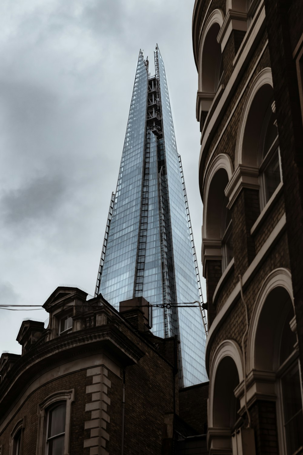 gray concrete building under cloudy sky during daytime