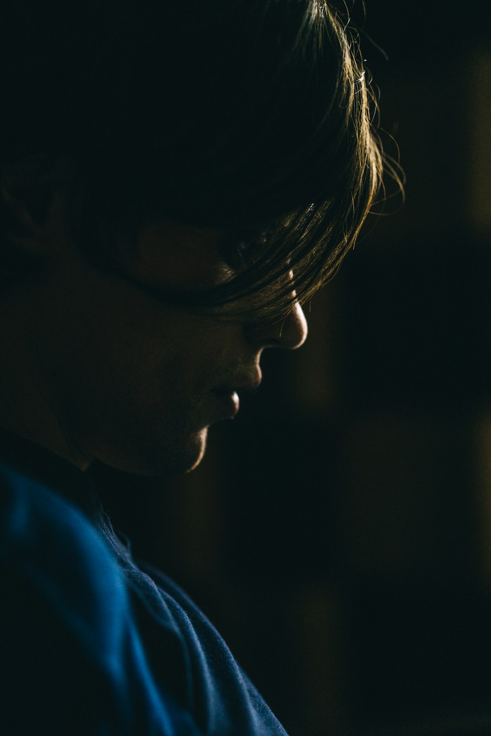 woman in blue collared shirt wearing black framed eyeglasses