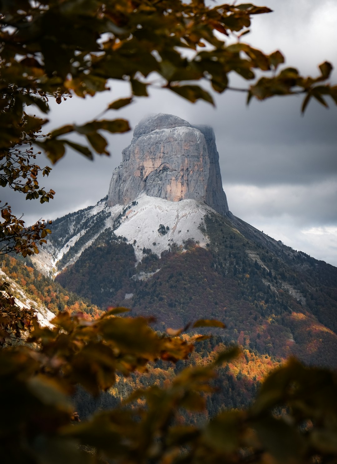 brown and white mountain under white clouds