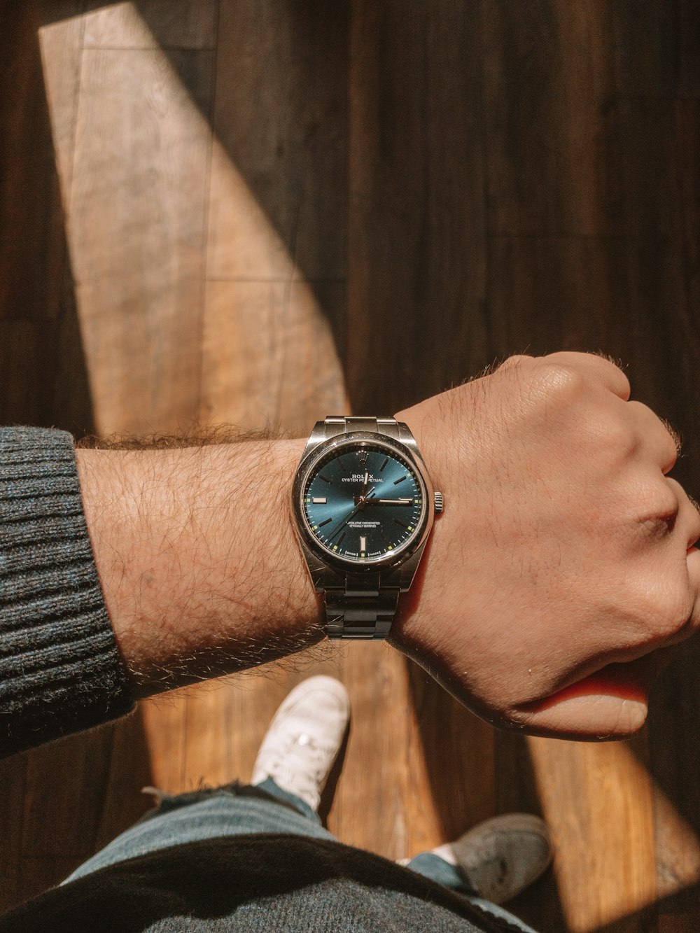 person wearing silver round analog watch