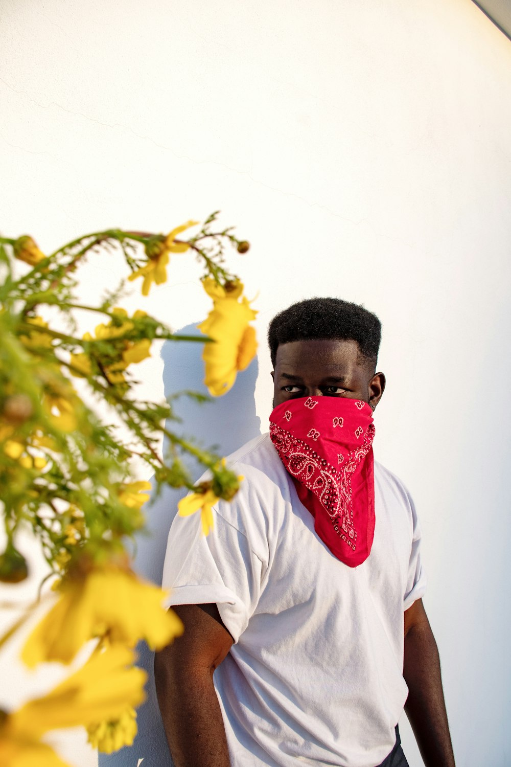 man in white crew neck t-shirt wearing red mask