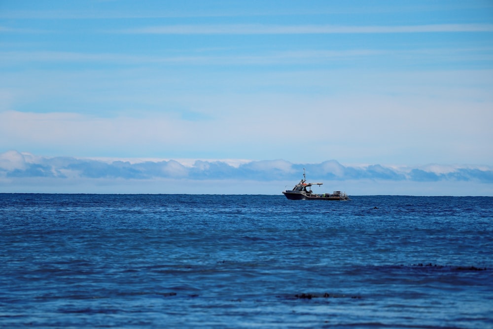 a small boat floating on top of a large body of water