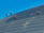 Claritypro workers in safety gear cleaning a construction site under clear blue skies