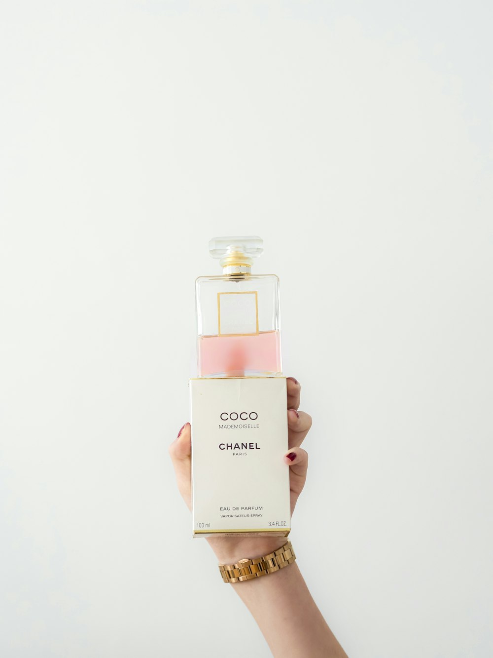 a hand holding a bottle of coco coco chanel