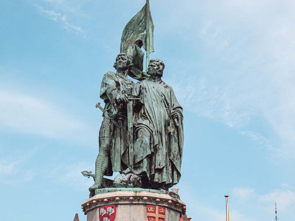 man riding on horse statue under blue sky during daytime