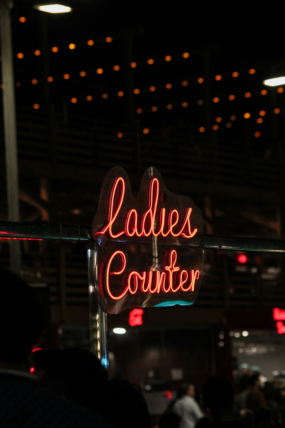 a neon sign that reads ladies counter