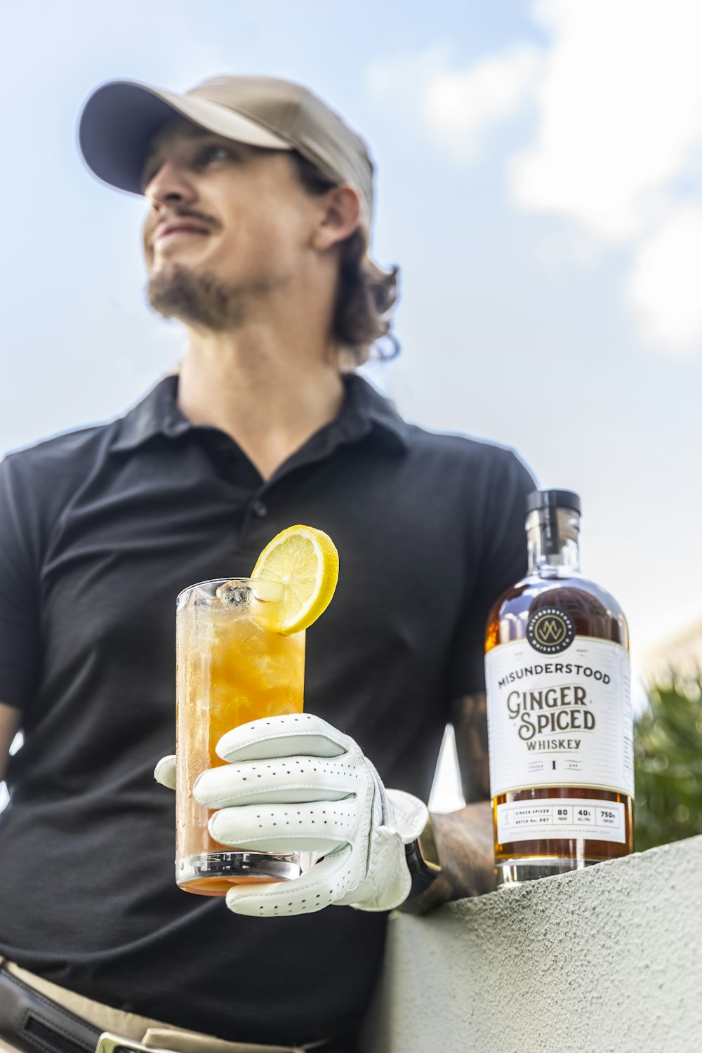 man in black polo shirt holding corona extra beer bottle