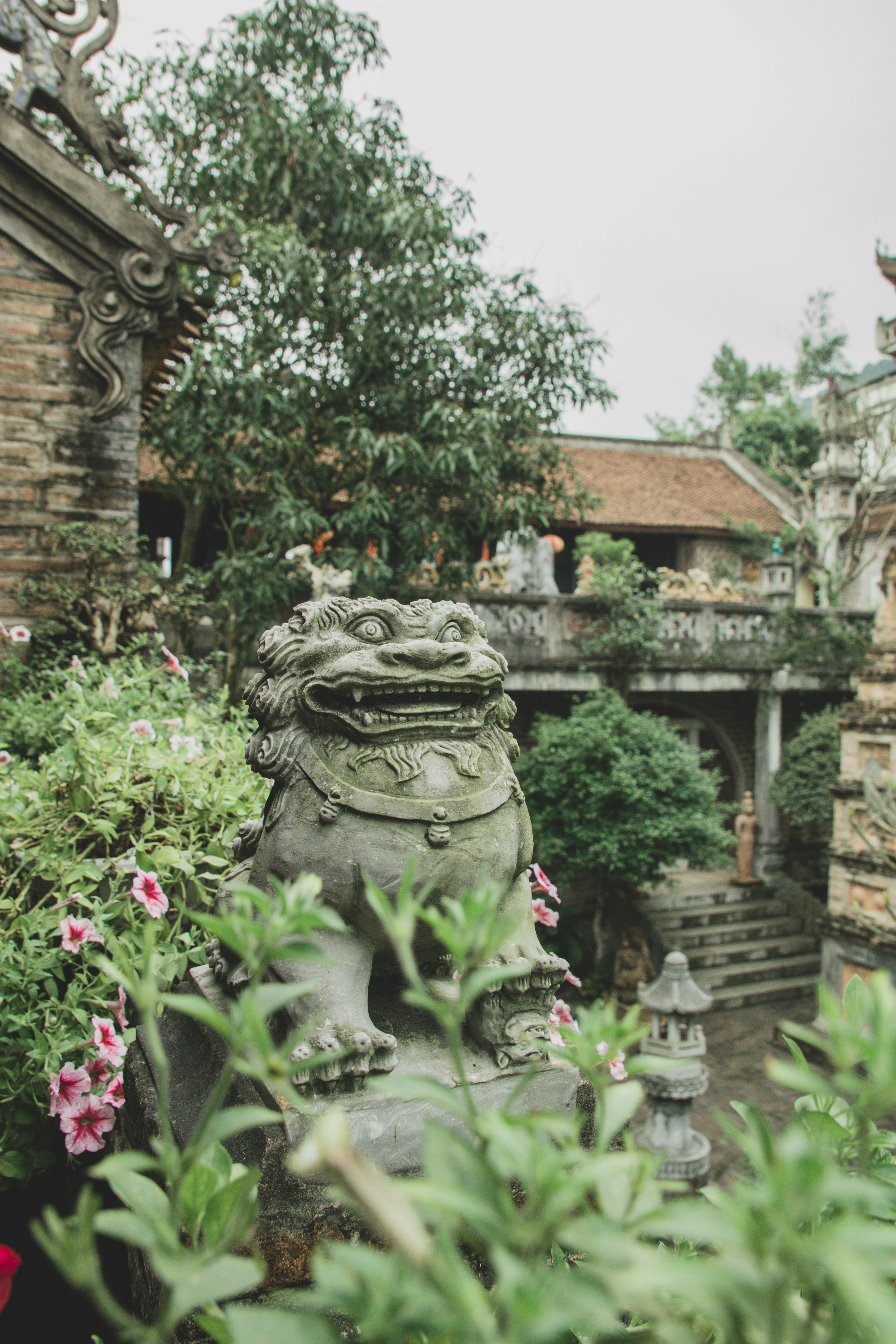 green concrete statue near brown brick building during daytime