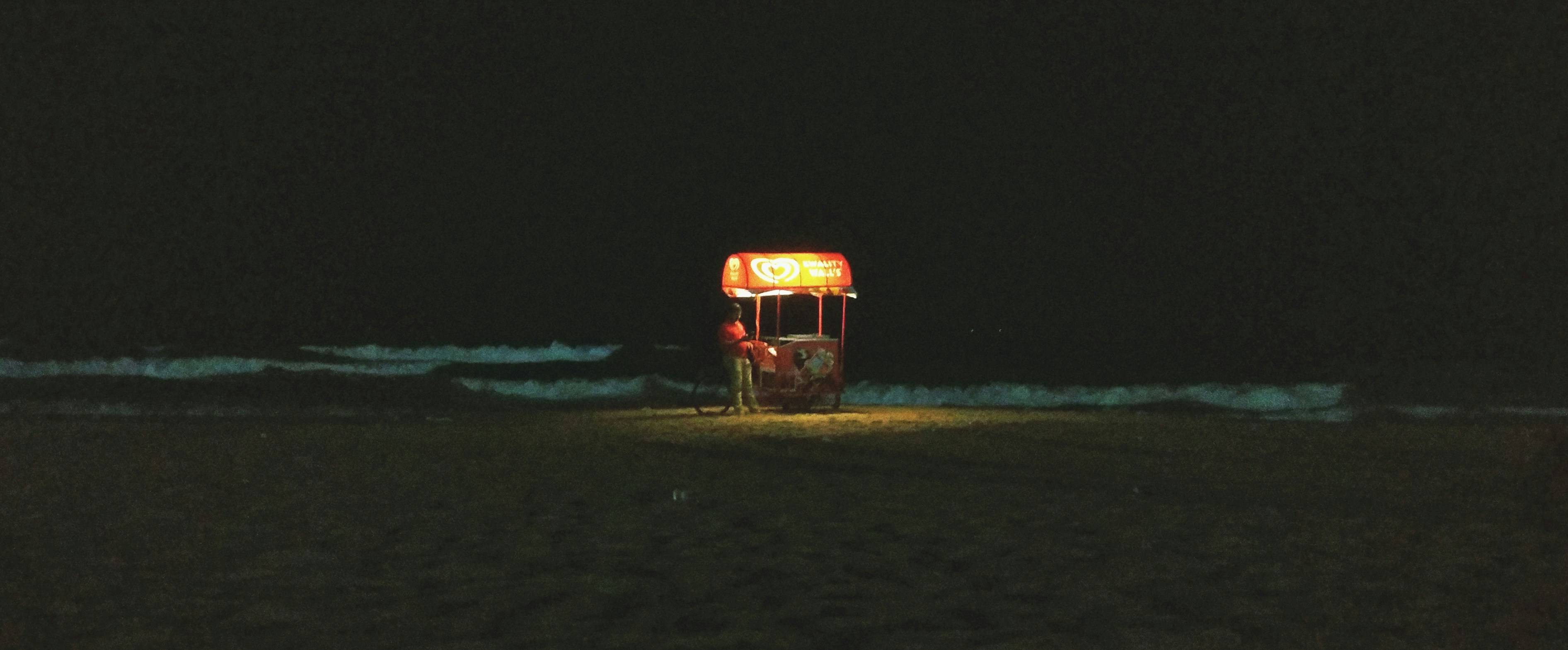 orange and black truck on brown sand during nighttime