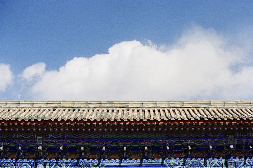 white clouds over brown building