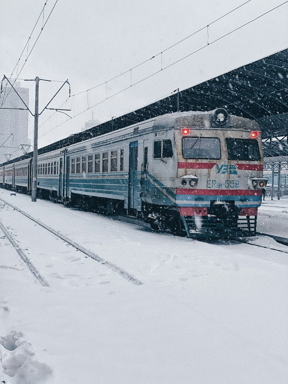 red and black train on snow covered ground during daytime