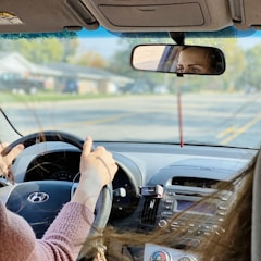 person driving car during daytime