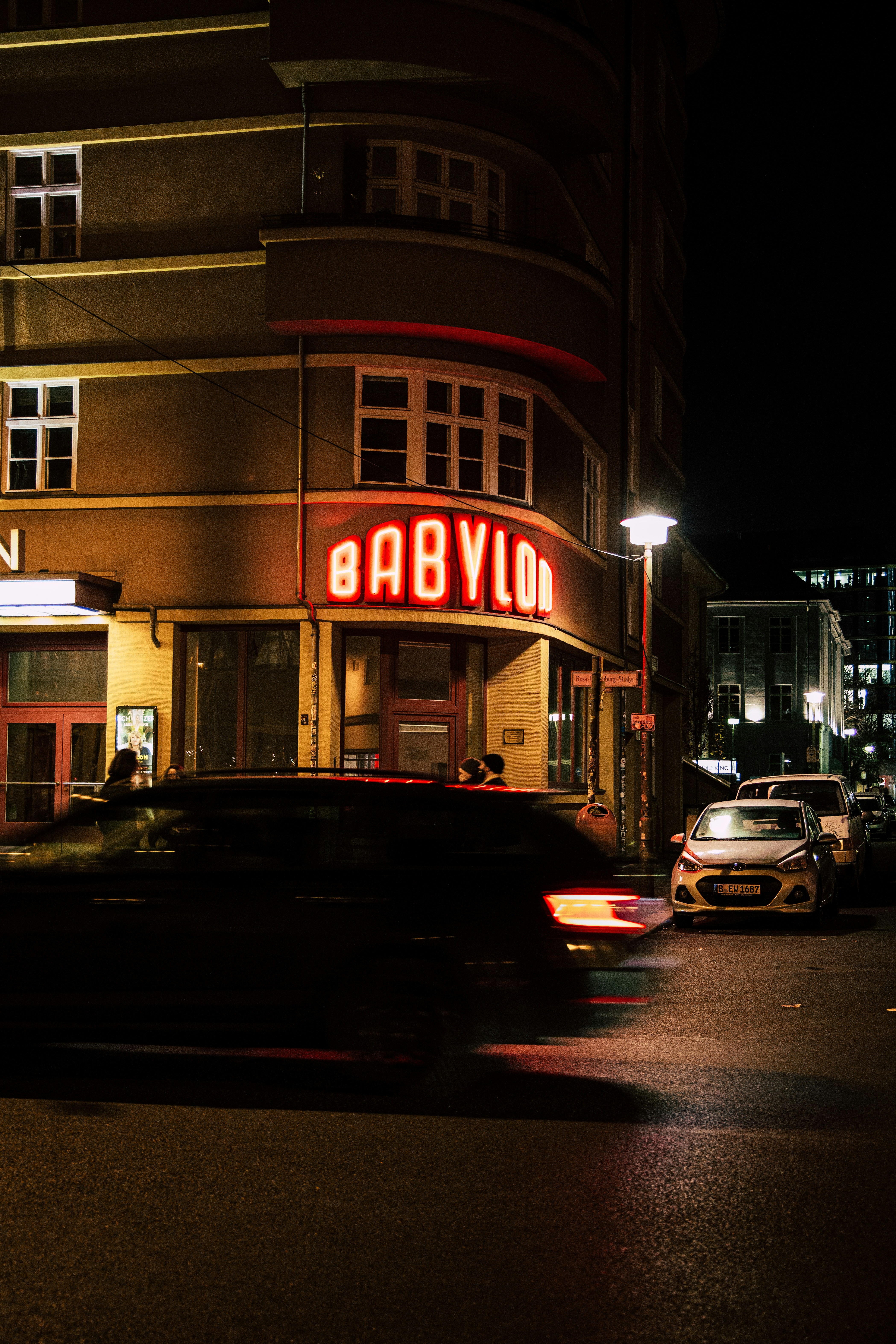 cars parked in front of store during night time