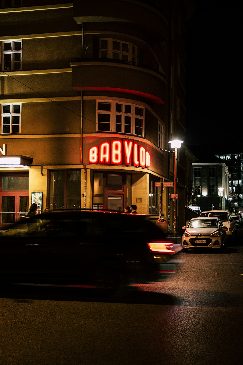 cars parked in front of store during night time