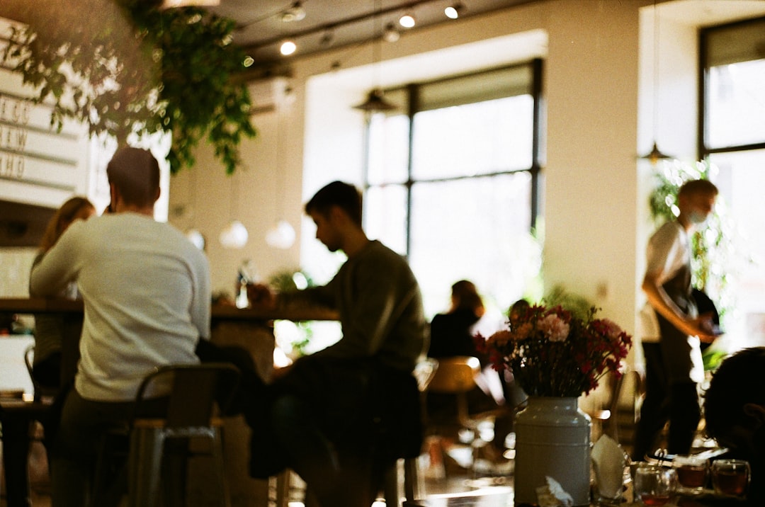 man in white dress shirt sitting on chair