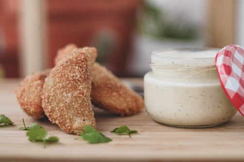 Close-up of crispy chicken wings on a rustic wooden platter.