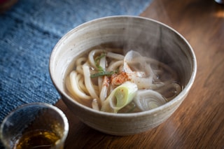 a bowl of soup with noodles and vegetables