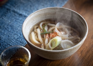 a bowl of soup with noodles and vegetables