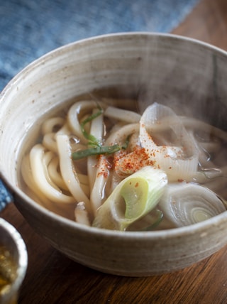 a bowl of soup with noodles and vegetables