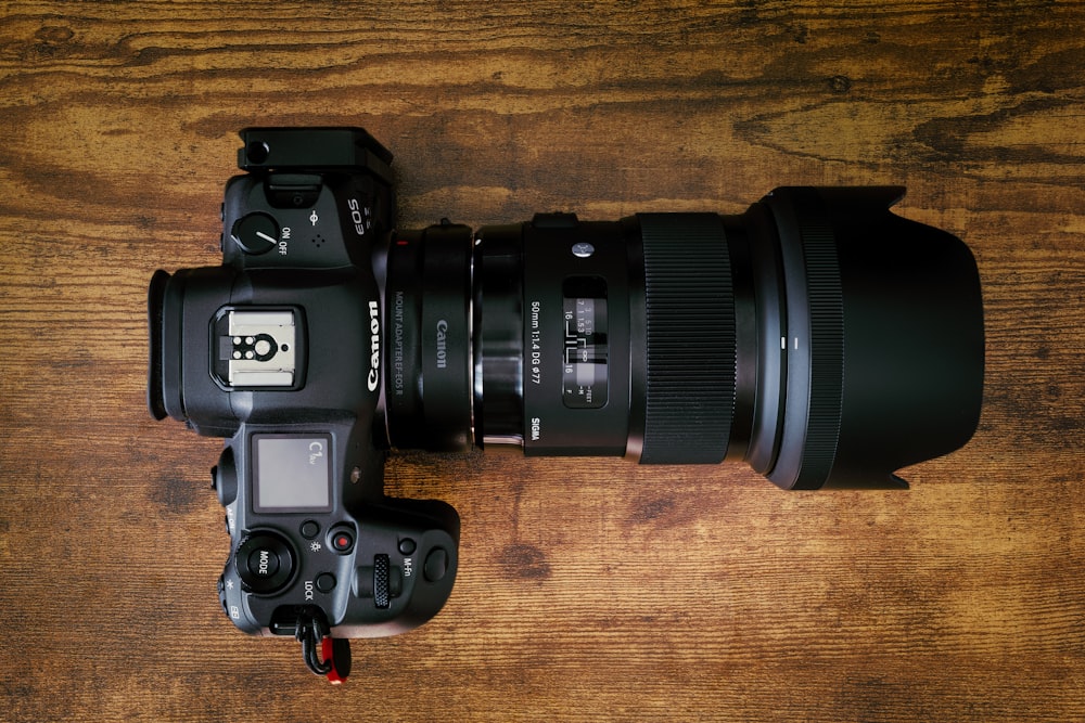 black nikon dslr camera on brown wooden table