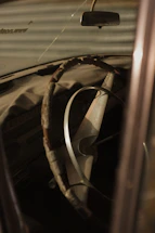 A close-up of a car interior covered in dirt and stains before cleaning.