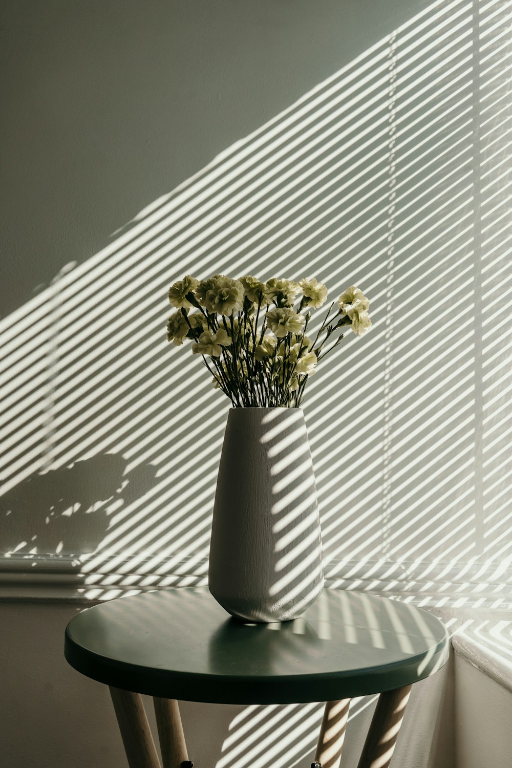 gold and white flower in white ceramic vase