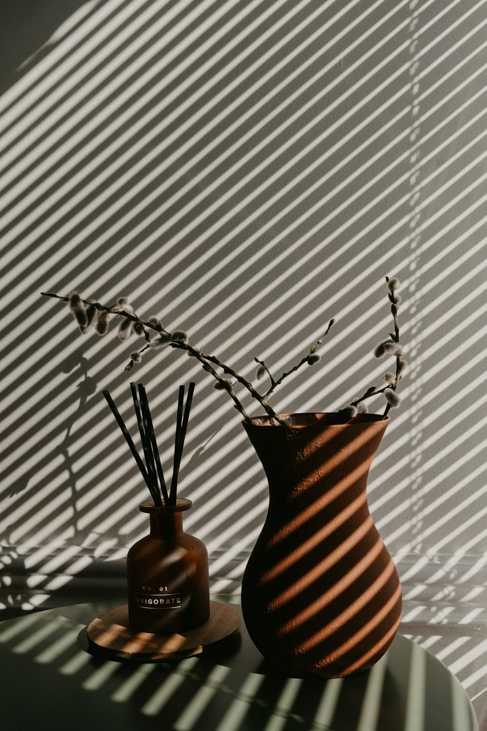 brown ceramic vase with silver spoon