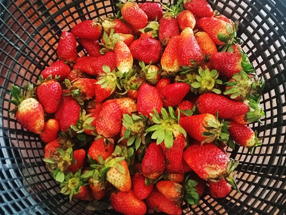 strawberries on black plastic basket