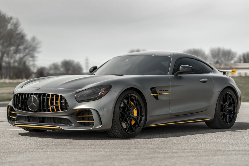 black mercedes benz coupe on gray asphalt road