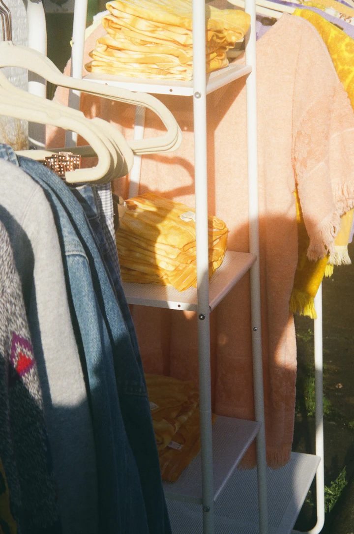 blue denim jeans on white plastic clothes hanger
