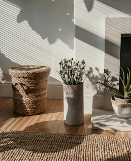 Close-up of natural textures: woven baskets, soft linens, and terracotta ceramics in a sunlit corner