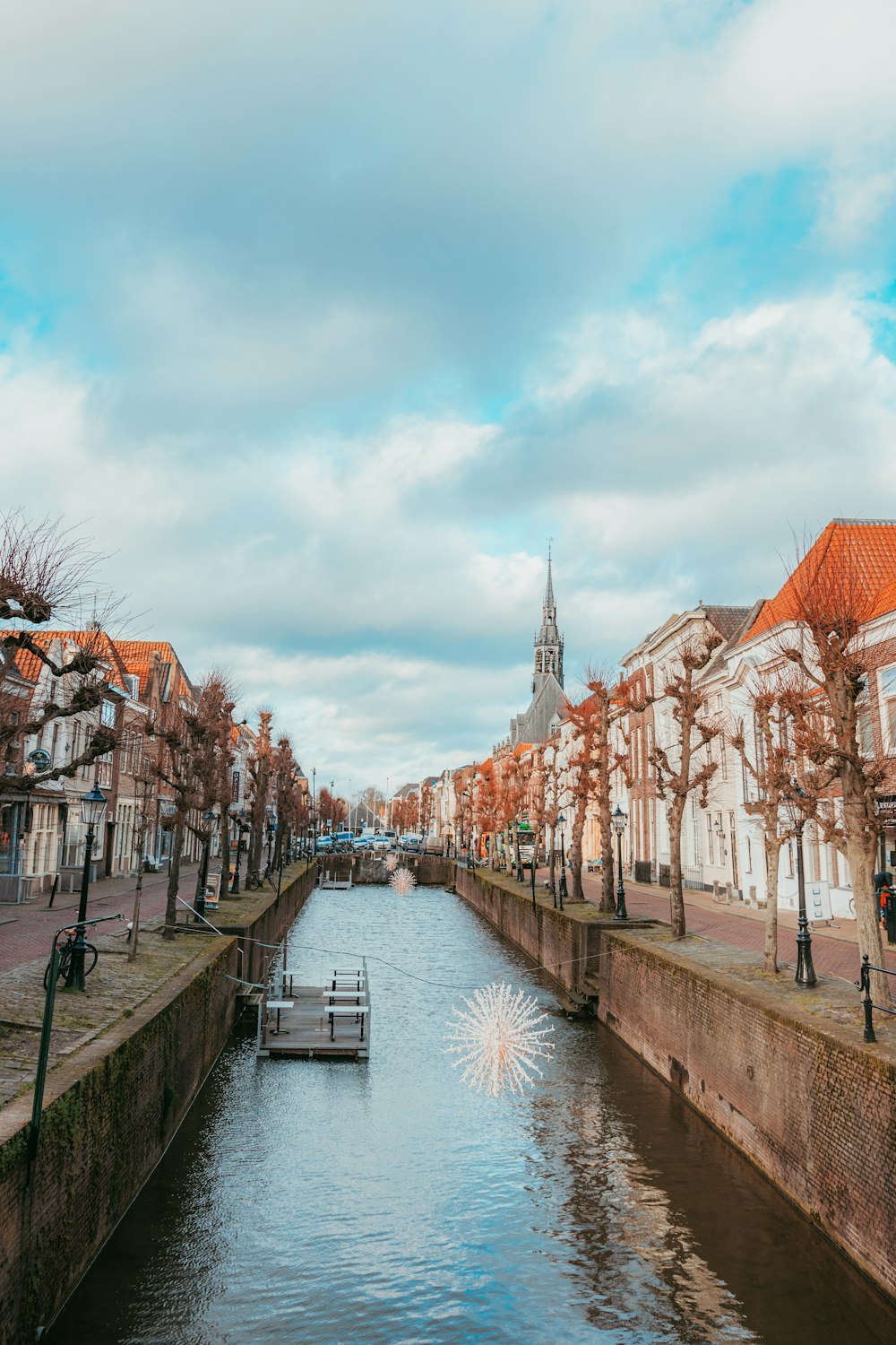 river between houses under cloudy sky during daytime