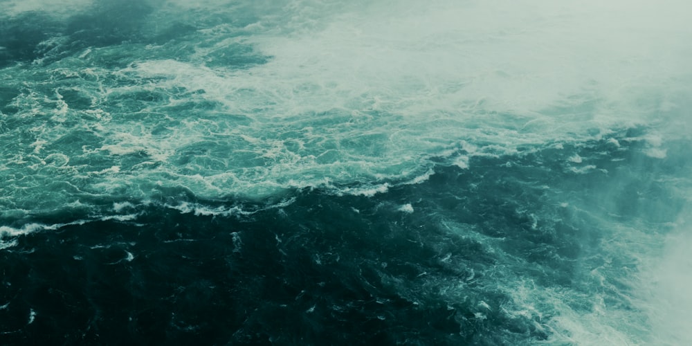 ocean waves crashing on shore during daytime