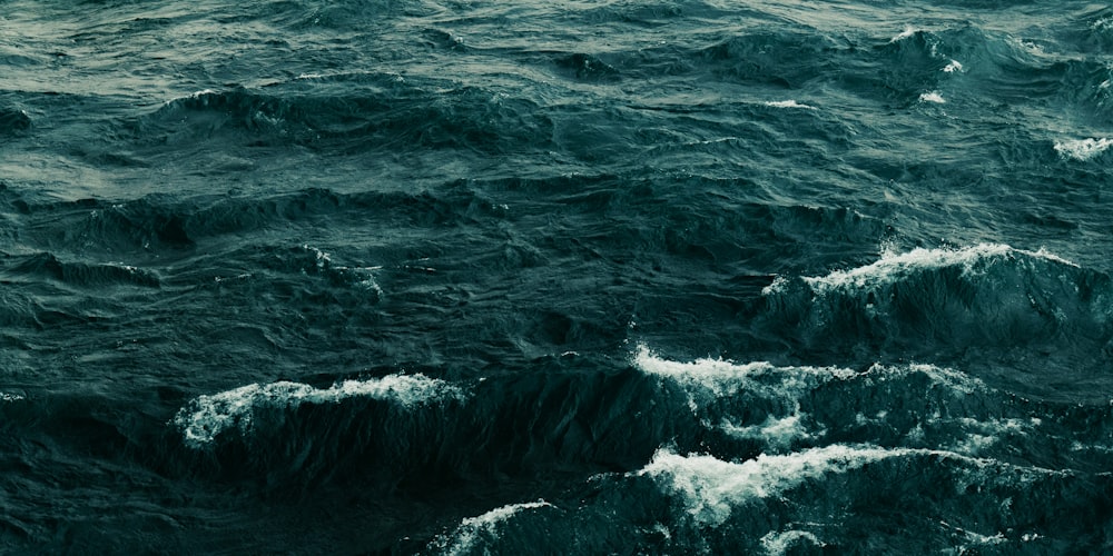 ocean waves crashing on shore during daytime