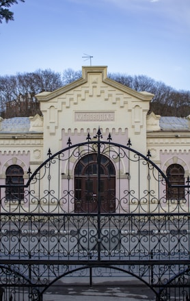 black metal gate on white concrete building