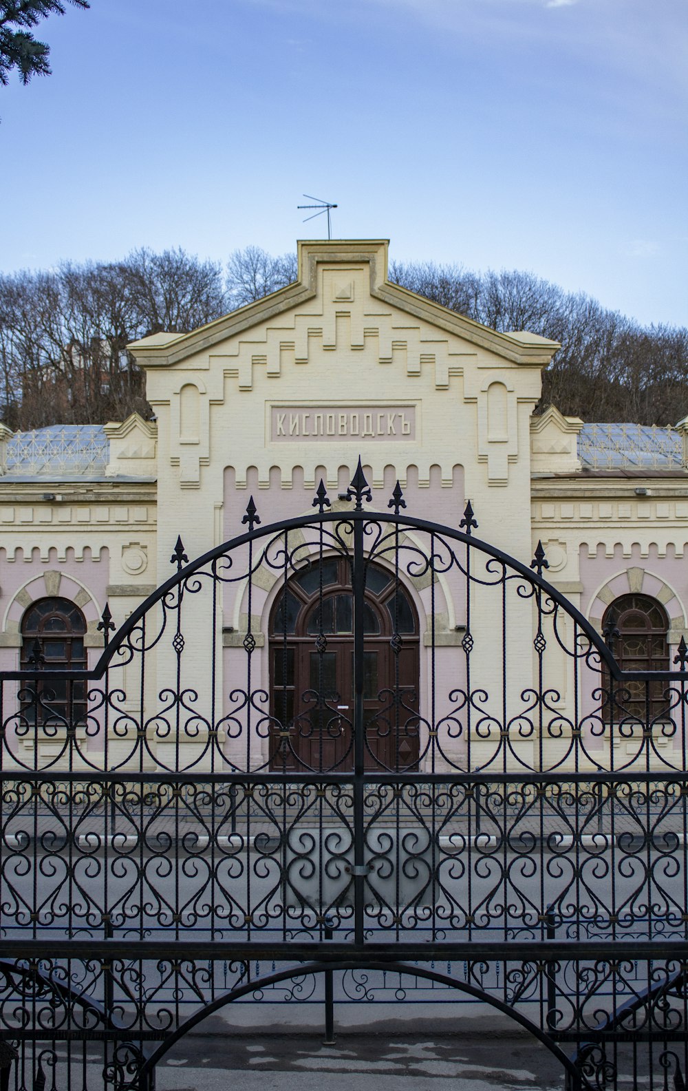 black metal gate on white concrete building