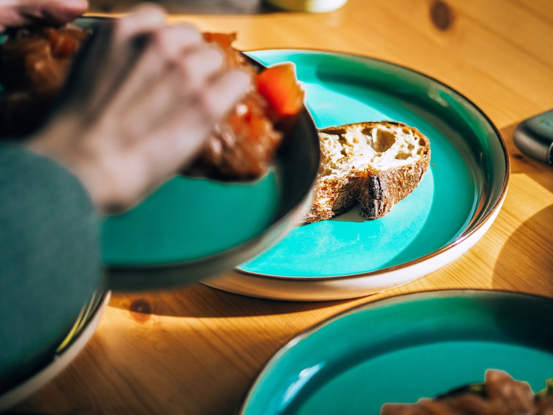 blue and white ceramic plate on brown wooden table