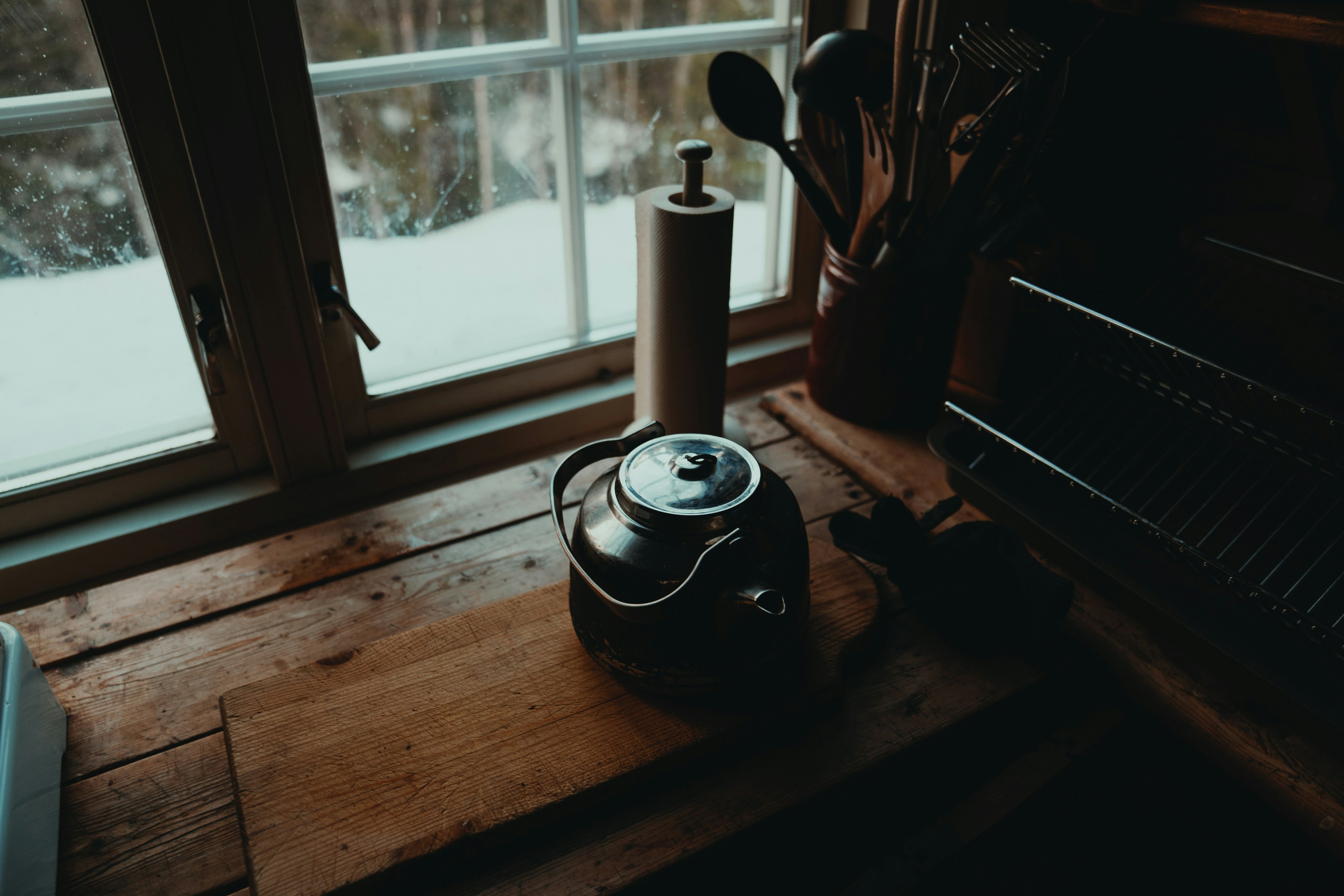 black and silver electric kettle beside window