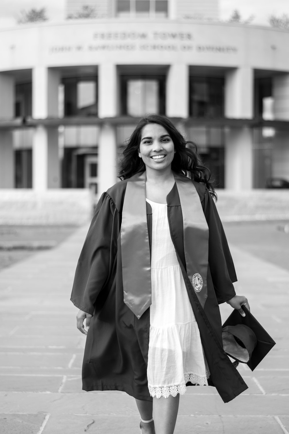 woman in black coat standing on sidewalk during daytime