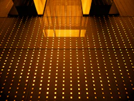 Golden geometric matrices glowing faintly in the dark, resembling a high-tech compass overlay.