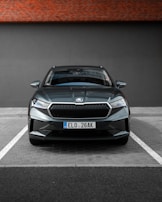 Side view of a compact car in a modern parking lot, emphasizing its sleek lines and condition.